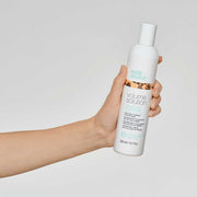 milk-shake-volume-conditioner-in-hand